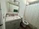Bathroom with a stylish vanity, decorative mirror, and shower with patterned curtain at 5157 New Bedford Dr, Las Vegas, NV 89122