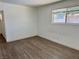 This bright bedroom features laminate wood flooring and a large window at 5157 New Bedford Dr, Las Vegas, NV 89122