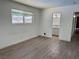 This bedroom has laminate wood flooring and a glimpse of the bathroom at 5157 New Bedford Dr, Las Vegas, NV 89122