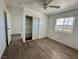 Bedroom with wood-look floors, ceiling fan, and closet with shelving at 5157 New Bedford Dr, Las Vegas, NV 89122