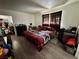 Bedroom with wood-look floors, window with curtains, and lots of storage at 5157 New Bedford Dr, Las Vegas, NV 89122