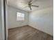 Bright bedroom features wood-look floors and a ceiling fan at 5157 New Bedford Dr, Las Vegas, NV 89122