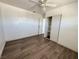 Bedroom featuring wood-look floors, ceiling fan, and closet with shelves at 5157 New Bedford Dr, Las Vegas, NV 89122