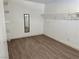 Walk-in closet with wood-look floors, adjustable shelving and a mirror at 5157 New Bedford Dr, Las Vegas, NV 89122