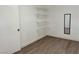 Walk-in closet with wood-look floors and built-in shelving at 5157 New Bedford Dr, Las Vegas, NV 89122