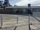 Front exterior of home featuring a metal white fence and secure gated parking at 5157 New Bedford Dr, Las Vegas, NV 89122