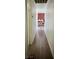 Hallway with wood flooring and view to a room with a red brick wall at 5157 New Bedford Dr, Las Vegas, NV 89122