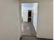 Hallway with wood-look flooring connects to various rooms, including a bathroom at 5157 New Bedford Dr, Las Vegas, NV 89122