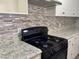 Kitchen includes tile backsplash, granite countertops, stainless steel appliances, and white cabinetry at 5157 New Bedford Dr, Las Vegas, NV 89122