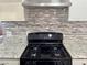 Updated kitchen features modern appliances, granite countertops, and tile backsplash at 5157 New Bedford Dr, Las Vegas, NV 89122
