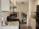 Kitchen featuring updated counters, white cabinetry and natural lighting at 5157 New Bedford Dr, Las Vegas, NV 89122