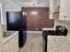 Updated kitchen features stainless steel appliances, granite countertops, and brick accent wall at 5157 New Bedford Dr, Las Vegas, NV 89122