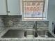 Close up of kitchen sink with stainless steel basin and granite countertops at 5157 New Bedford Dr, Las Vegas, NV 89122
