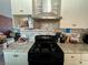 Updated kitchen featuring a modern range hood and tiled backsplash at 5157 New Bedford Dr, Las Vegas, NV 89122
