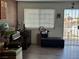 A front living area featuring a window and door with security bars, along with a brick accent wall at 5157 New Bedford Dr, Las Vegas, NV 89122