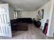 Inviting living room featuring a comfortable sectional sofa, a large television, and stylish wood-look floors at 5157 New Bedford Dr, Las Vegas, NV 89122