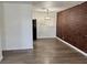Inviting living room with wood-look floors and a brick accent wall at 5157 New Bedford Dr, Las Vegas, NV 89122