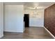 Inviting living room with wood-look floors and a brick accent wall at 5157 New Bedford Dr, Las Vegas, NV 89122