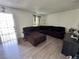 Spacious living room featuring modern wood-look floors and a comfortable, large sectional sofa at 5157 New Bedford Dr, Las Vegas, NV 89122