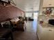 Open-concept layout with brick wall, connecting the kitchen and front entryway with natural light at 5157 New Bedford Dr, Las Vegas, NV 89122