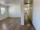 Spacious living room featuring wood-look floors and access to hallway at 5157 New Bedford Dr, Las Vegas, NV 89122
