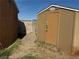 An outdoor shed offers convenient storage, complemented by partial landscaping and perimeter block wall at 5157 New Bedford Dr, Las Vegas, NV 89122