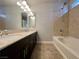 Full bathroom featuring double sinks, dark cabinets and a shower-tub combo at 6020 Arbor Downs Ave, Las Vegas, NV 89139