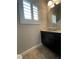 Elegant powder room with a marble countertop and plantation shutters at 6020 Arbor Downs Ave, Las Vegas, NV 89139