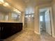 Bathroom boasts double vanity with dark wood cabinets, tiled floor and walk-in shower with glass doors at 6020 Arbor Downs Ave, Las Vegas, NV 89139