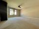 Spacious bedroom features neutral carpeting, a ceiling fan and a double window with horizontal blinds at 6020 Arbor Downs Ave, Las Vegas, NV 89139
