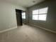 Neutral bedroom with mirrored closet doors and ample natural light at 6020 Arbor Downs Ave, Las Vegas, NV 89139