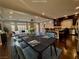Open-concept dining area with modern furnishings, flowing into a living space featuring hardwood floors and neutral tones at 6020 Arbor Downs Ave, Las Vegas, NV 89139