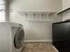 Functional laundry room equipped with washer, dryer, and shelving at 6020 Arbor Downs Ave, Las Vegas, NV 89139