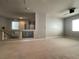 Open loft area featuring neutral carpeting, a ceiling fan, and views of the downstairs entryway and laundry room at 6020 Arbor Downs Ave, Las Vegas, NV 89139
