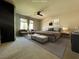 Spacious main bedroom featuring neutral tones, plush carpet, and a ceiling fan at 6020 Arbor Downs Ave, Las Vegas, NV 89139