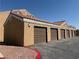 Row of attached garages with brown doors and a terracotta tile roof above at 8101 W Flamingo Rd # 1044, Las Vegas, NV 89147