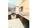 Modern kitchen with stainless steel appliances, dark cabinets, and tile flooring at 8101 W Flamingo Rd # 1044, Las Vegas, NV 89147
