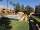 Community pool surrounded by lush landscaping and well-maintained grounds at 8101 W Flamingo Rd # 1044, Las Vegas, NV 89147
