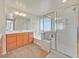 Bright bathroom with a large soaking tub, glass-enclosed shower, double sink vanity, and wood-look flooring at 8919 Don Valley Ave, Las Vegas, NV 89148