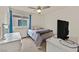 Inviting bedroom with light walls, a large window, and a ceiling fan at 8919 Don Valley Ave, Las Vegas, NV 89148