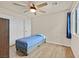 Cozy bedroom with wood-look flooring, ceiling fan, and natural light at 8919 Don Valley Ave, Las Vegas, NV 89148