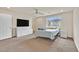Spacious bedroom with soft carpet, ceiling fan, large window, and white furniture creating a calm retreat at 8919 Don Valley Ave, Las Vegas, NV 89148