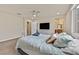 Relaxing bedroom with a ceiling fan, neutral walls, a large window, and access to an ensuite bathroom at 8919 Don Valley Ave, Las Vegas, NV 89148