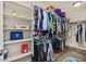 Organized walk-in closet with shelves, hanging racks, and carpet, offering ample storage space for clothing at 8919 Don Valley Ave, Las Vegas, NV 89148