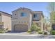 Two-story home with a two car garage and desert landscaping at 8919 Don Valley Ave, Las Vegas, NV 89148