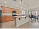 Bright kitchen features wood cabinets, stainless steel appliances, and an island with seating, perfect for casual dining at 8919 Don Valley Ave, Las Vegas, NV 89148