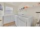 Well-lit laundry room with storage cabinets and modern, front-loading machines at 8919 Don Valley Ave, Las Vegas, NV 89148