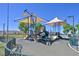 Community playground featuring modern play equipment, a secure fence, and desert landscaping at 8919 Don Valley Ave, Las Vegas, NV 89148