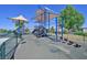 A modern playground features shade structures and is surrounded by fencing and desert landscaping at 8919 Don Valley Ave, Las Vegas, NV 89148