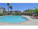 Sparkling community pool with lounge chairs and meticulously maintained landscaping in a gated community at 8919 Don Valley Ave, Las Vegas, NV 89148
